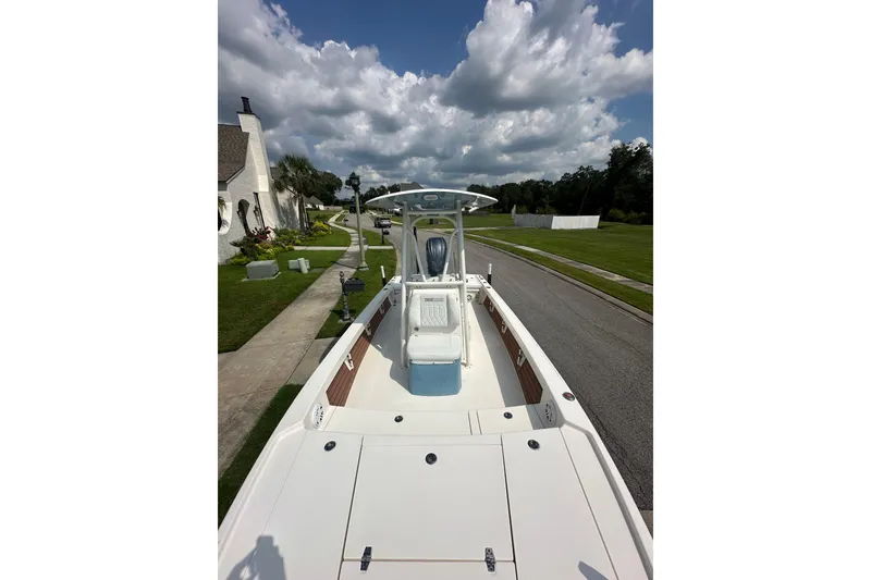 Slide: The Image of 2021 Pathfinder 2500 Hybrid boat on a residential street under cloudy sky. - 19
