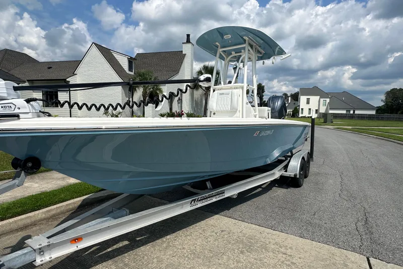 Slide: The Image of 2021 Pathfinder 2500 Hybrid boat on trailer in suburban neighborhood. - 3