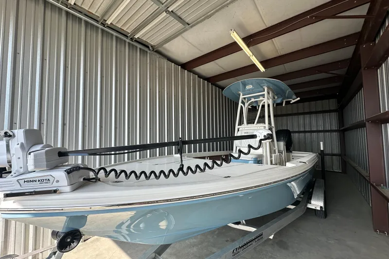 Slide: The Image of 2021 Pathfinder 2500 Hybrid boat in storage, featuring Minn Kota trolling motor. - 7