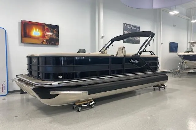 Slide: The Image of 2026 Bentley Pontoons Legacy 223 Navigator in showroom, sleek design, luxury pontoon boat. - 0