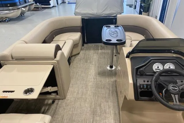 Slide: The Image of 2026 Bentley Pontoons Legacy 223 Navigator interior with beige seating and modern dashboard. - 19