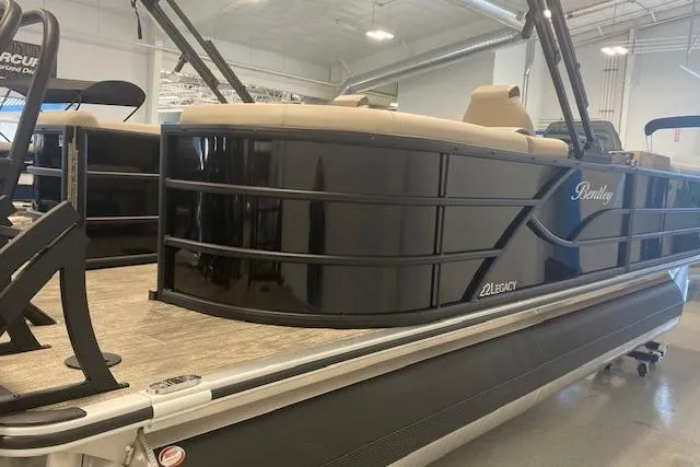 Slide: The Image of 2026 Bentley Pontoons Legacy 223 Navigator, sleek black design, showcased indoors. - 3