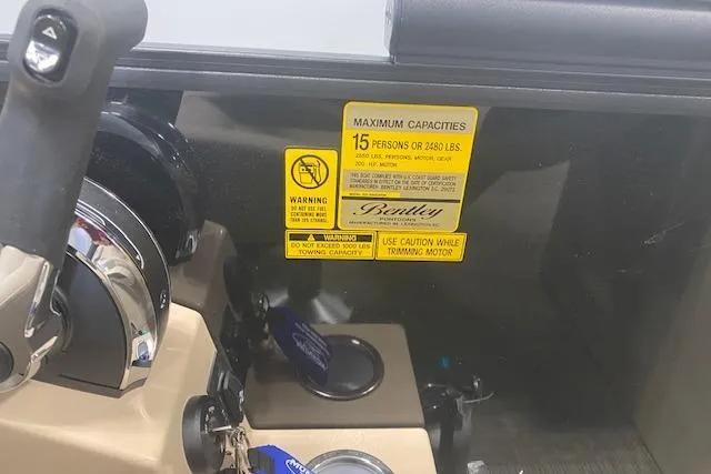 Slide: The Image of Control panel of 2026 Bentley Pontoons Legacy 223 Navigator with capacity warning label. - 9