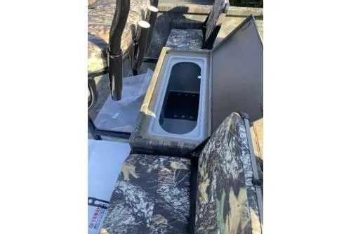 Slide: The Image of 2026 G3 Sportsman 1710 PFX boat interior with camo seats and storage compartment. - 2