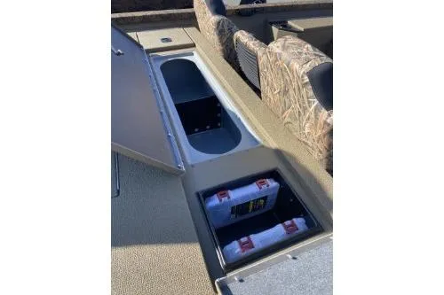Slide: The Image of 2026 G3 Sportsman 1710 PFX boat storage compartments with camouflage seating. - 3