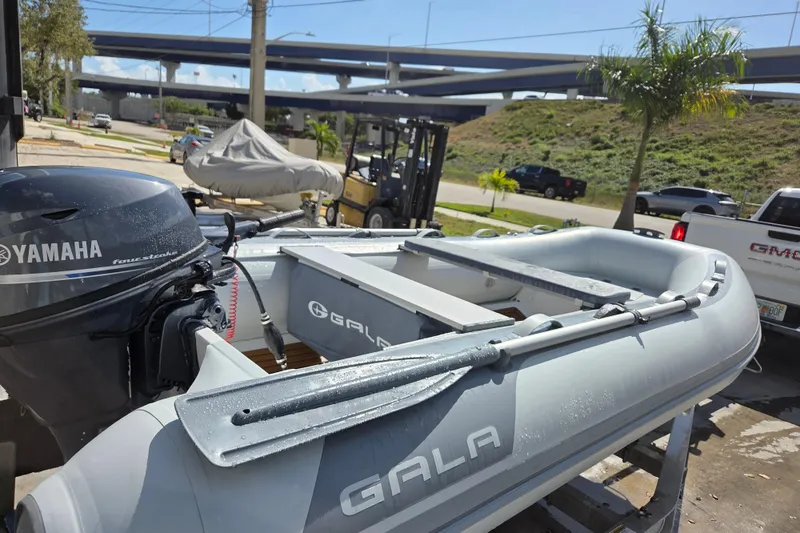 Slide: The Image of 2026 Gala A330HD inflatable boat with Yamaha motor, parked outdoors. - 4