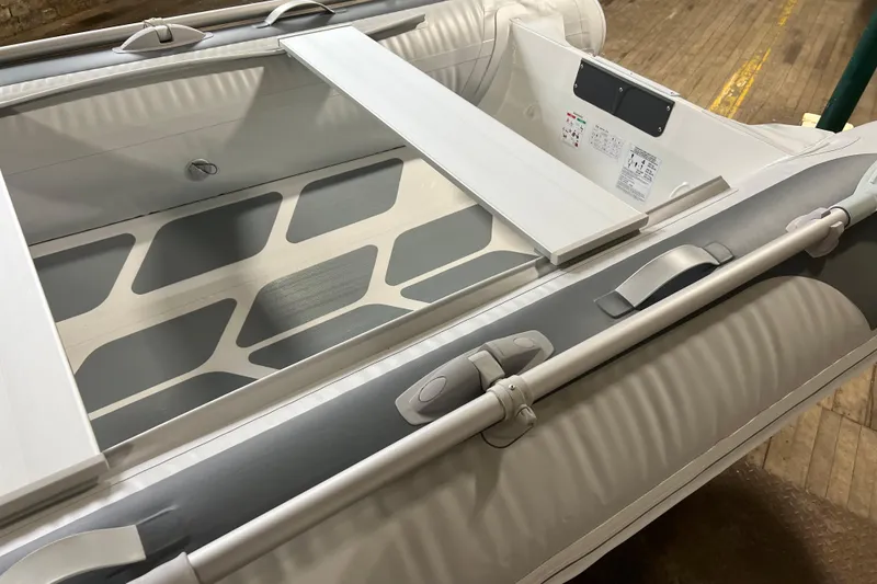 Slide: The Image of 2026 Gala A330HD inflatable boat interior with oars and seating on wooden floor. - 9