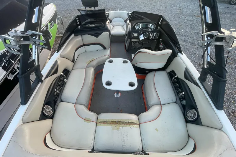 Slide: The Image of 2011 Malibu Wakesetter 21 VLX interior with seating and dashboard view. - 11