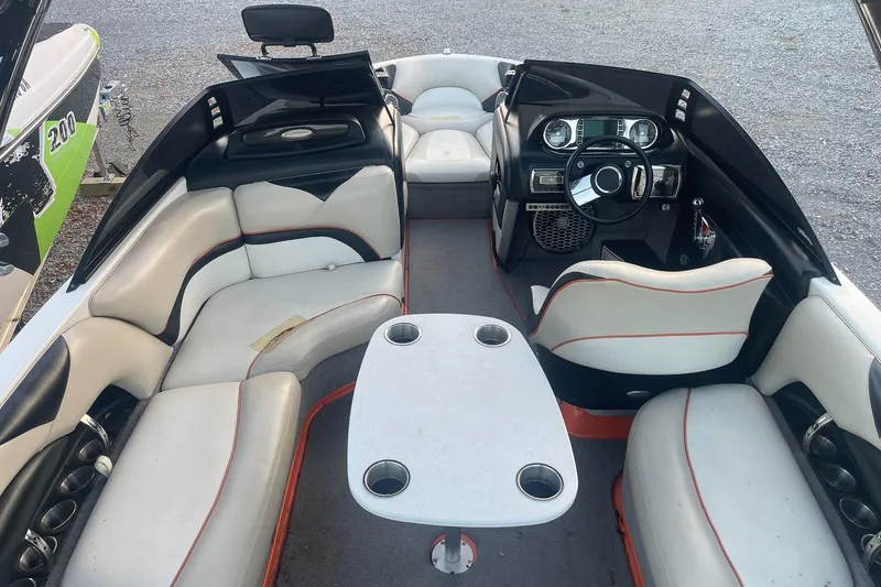 Slide: The Image of Interior of a 2011 Malibu Wakesetter 21 VLX boat with seating and steering console. - 12