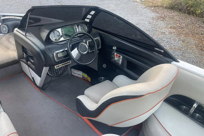 Slide: The Image of 2011 Malibu Wakesetter 21 VLX boat interior with steering wheel and dashboard controls. - 13