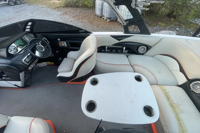 Slide: The Image of Interior of a 2011 Malibu Wakesetter 21 VLX boat with seating and dashboard. - 18