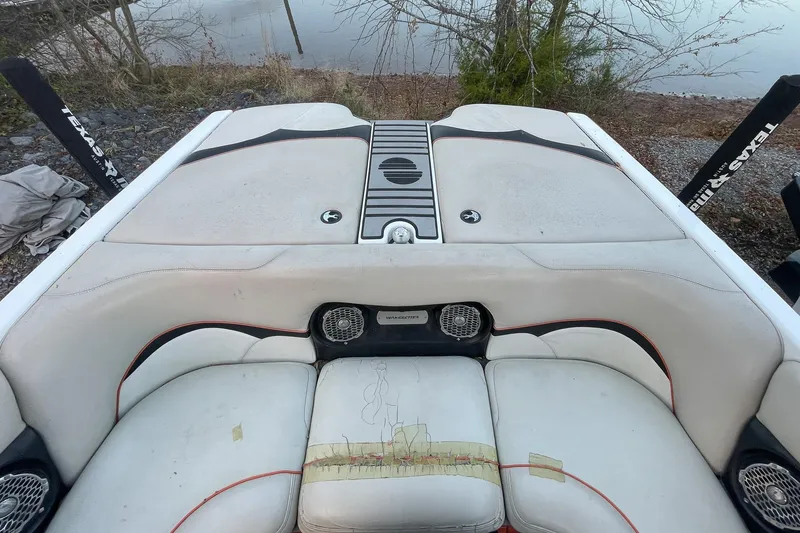 Slide: The Image of 2011 Malibu Wakesetter 21 VLX boat interior with worn seating and speakers. - 23
