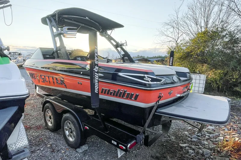 Slide: The Image of 2011 Malibu Wakesetter 21 VLX boat on trailer, parked outdoors. - 8