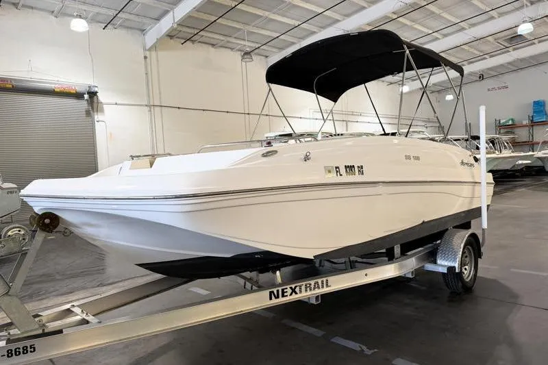 Slide: The Image of 2019 Hurricane SunDeck Sport 188 OB boat on trailer in indoor storage. - 1