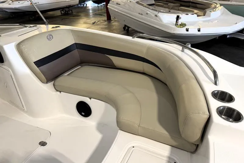 Slide: The Image of 2019 Hurricane SunDeck Sport 188 OB boat interior with beige seating and cup holders. - 19