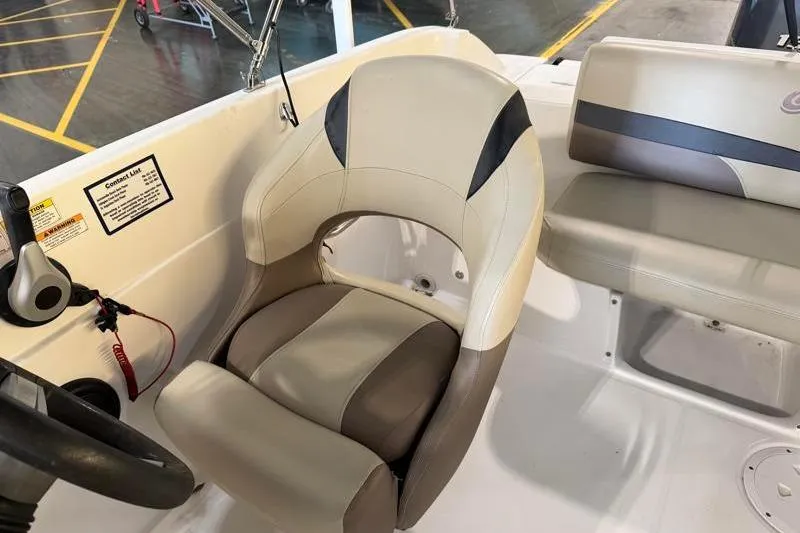 Slide: The Image of 2019 Hurricane SunDeck Sport 188 OB boat interior with beige seating and steering wheel. - 21