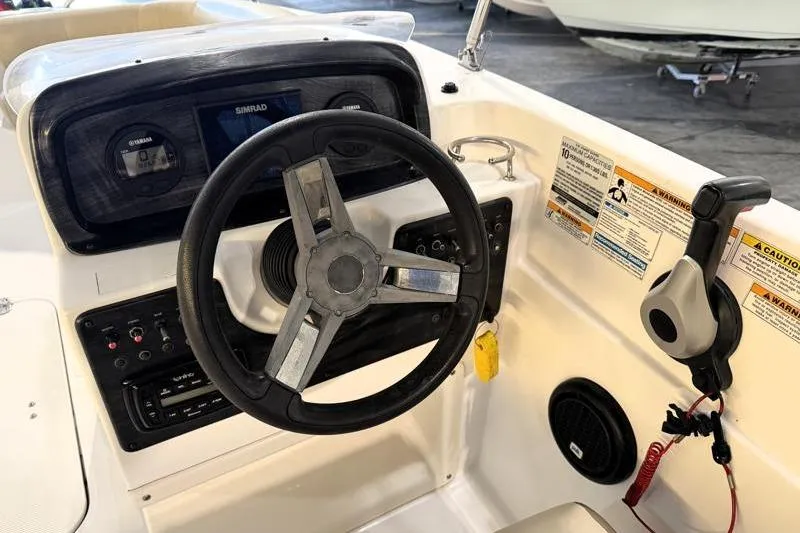 Slide: The Image of 2019 Hurricane SunDeck Sport 188 OB boat dashboard with steering wheel and controls. - 22
