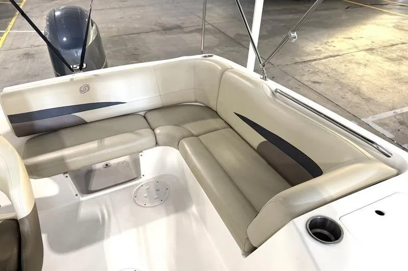 Slide: The Image of 2019 Hurricane SunDeck Sport 188 OB boat interior with beige seating and cup holder. - 26