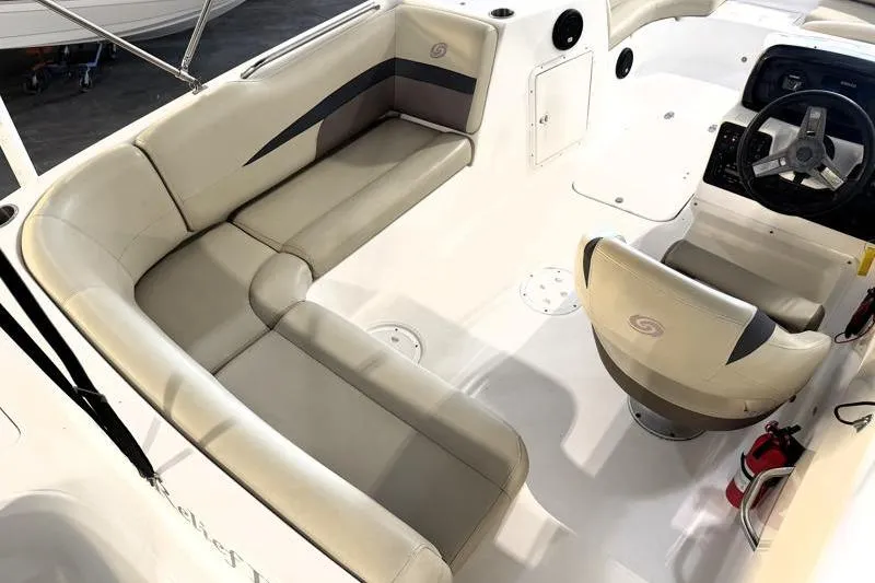 Slide: The Image of 2019 Hurricane SunDeck Sport 188 OB boat interior with beige seating and steering console. - 27