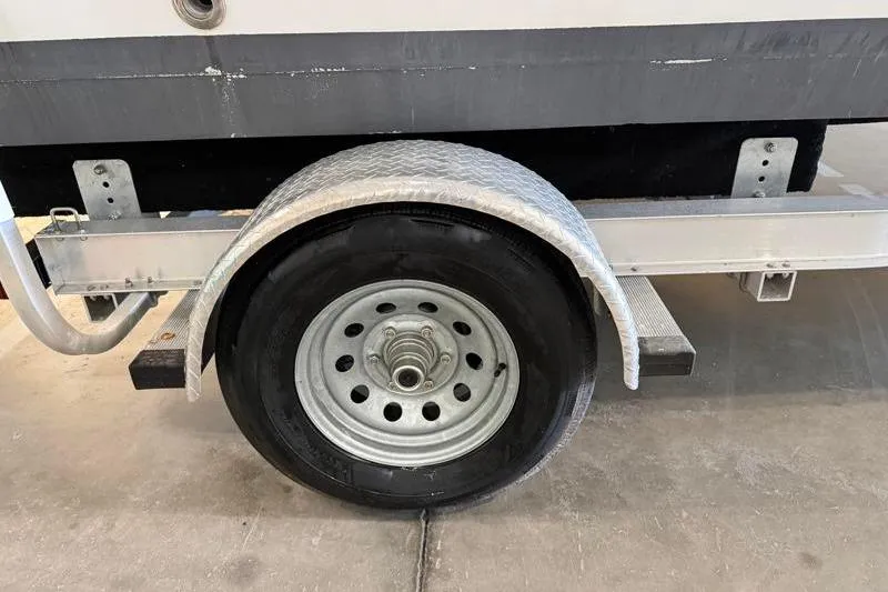 Slide: The Image of Trailer wheel of 2019 Hurricane SunDeck Sport 188 OB boat, parked indoors. - 30