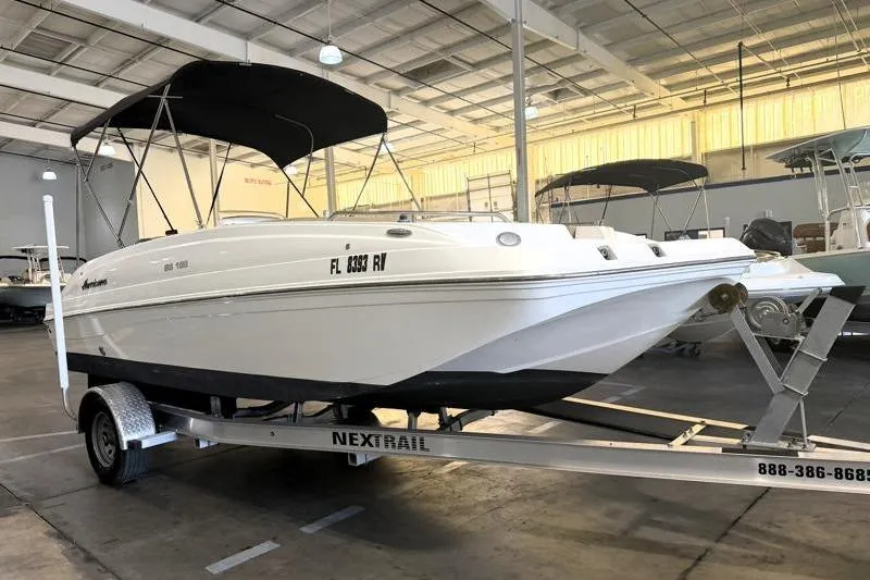 Slide: The Image of 2019 Hurricane SunDeck Sport 188 OB boat on trailer in indoor storage. - 4