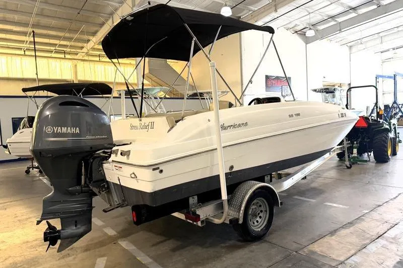 Slide: The Image of 2019 Hurricane SunDeck Sport 188 OB boat with Yamaha outboard motor in a showroom. - 5
