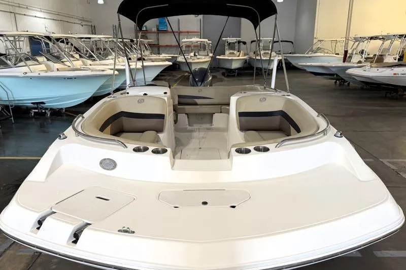 Slide: The Image of 2019 Hurricane SunDeck Sport 188 OB boat in showroom, featuring spacious seating and sleek design. - 6