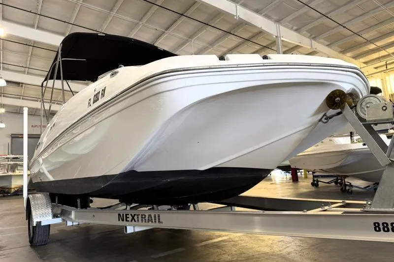 Slide: The Image of 2019 Hurricane SunDeck Sport 188 OB boat on trailer in indoor storage. - 8