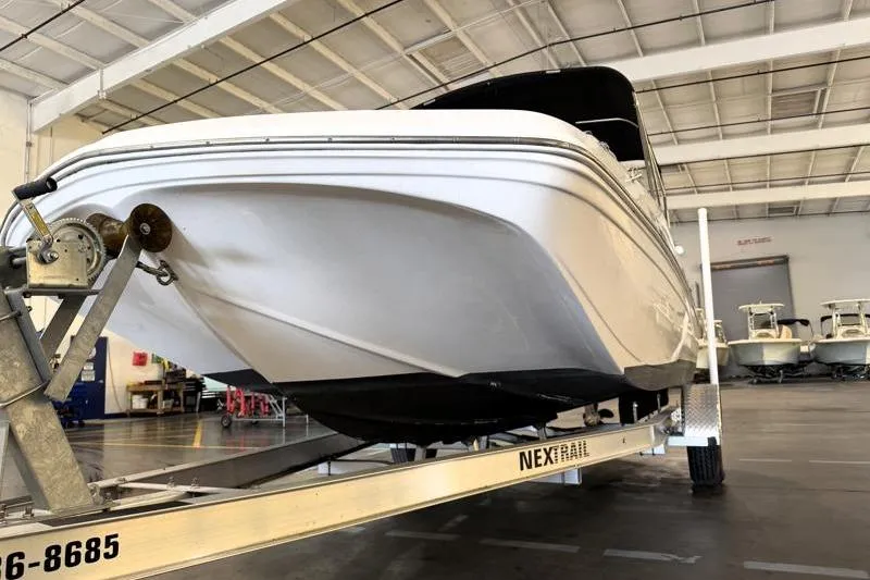 Slide: The Image of 2019 Hurricane SunDeck Sport 188 OB boat on trailer in indoor storage. - 9