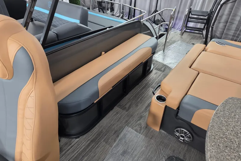 Slide: The Image of Luxurious interior of 2026 Godfrey Monaco 255 MTF pontoon boat with tan and gray seating. - 5