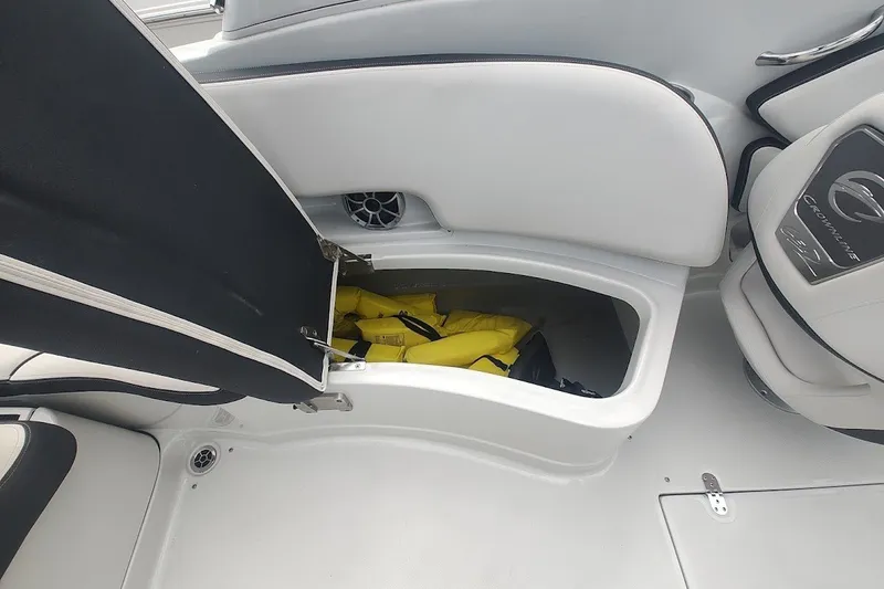Slide: The Image of Open storage compartment in 2022 Crownline 280 SS boat with life jackets inside. - 16