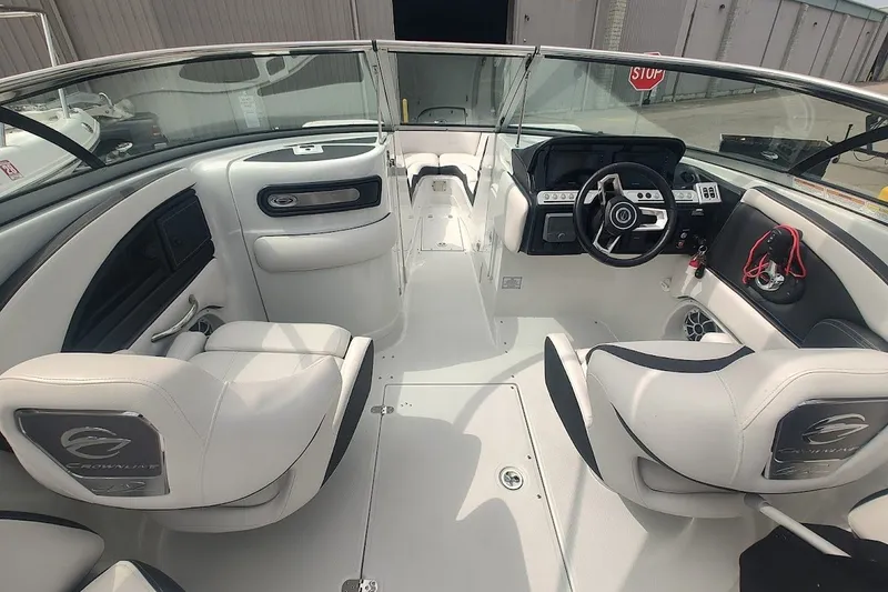 Slide: The Image of 2022 Crownline 280 SS boat interior with white seating and modern dashboard. - 22