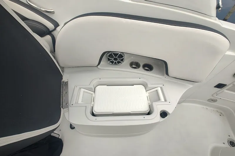 Slide: The Image of Interior of 2022 Crownline 280 SS boat with built-in cooler and cup holders. - 13