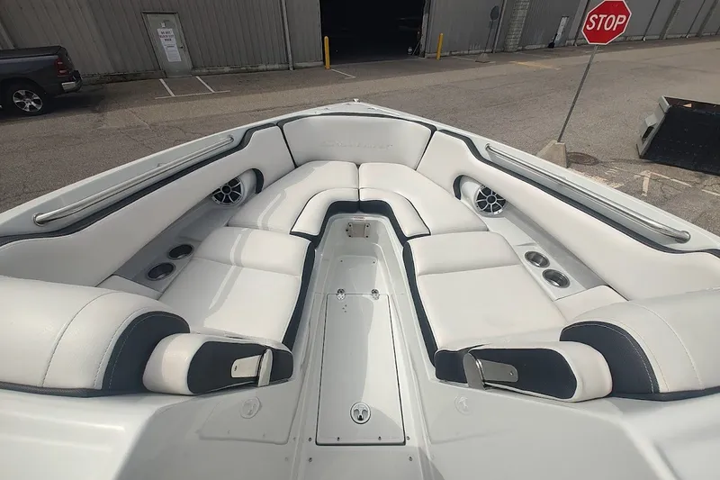 Slide: The Image of 2022 Crownline 280 SS boat interior with white seating and cup holders. - 21