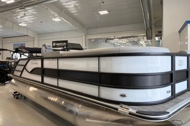 Slide: The Image of 2026 Bentley Pontoons Legacy 223 Swingback in showroom, showcasing sleek design and modern features. - 17