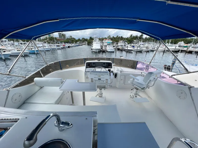 Slide: The Image of Flybridge of 2004 Ocean Alexander Atlus 48 yacht with marina view. - 2
