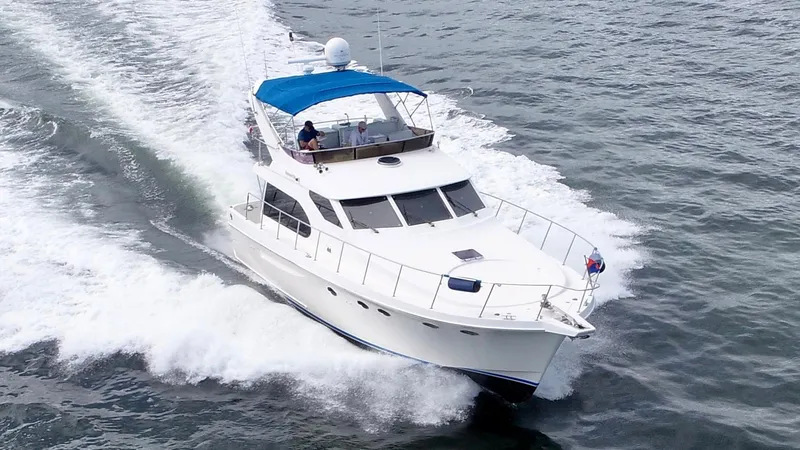 Slide: The Image of Ocean Alexander Atlus 48 yacht cruising on open water, 2004 model, with blue canopy. - 3