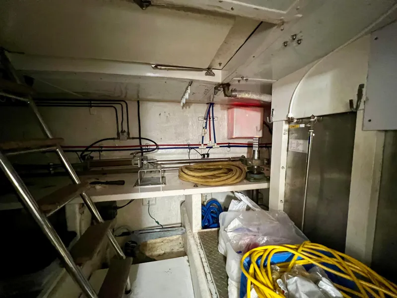 Slide: The Image of Engine room of 2004 Ocean Alexander Atlus 48 yacht, featuring equipment and storage. - 38