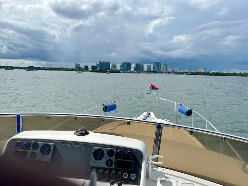 Slide: The Image of Ocean Alexander Atlus 48 yacht navigating towards city skyline under cloudy skies, 2004 model. - 8