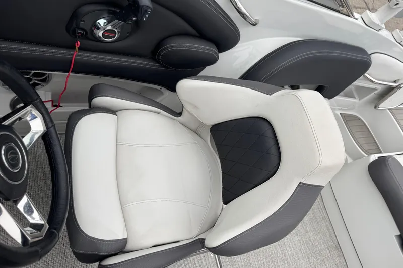 Slide: The Image of 2022 Crownline 255 SS boat interior with luxurious seating and steering wheel detail. - 13