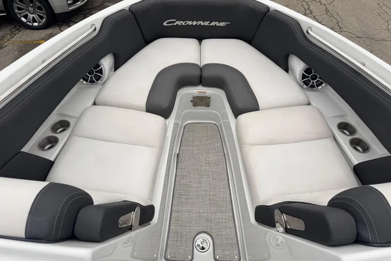 Slide: The Image of 2022 Crownline 255 SS boat interior with cushioned seating and cup holders. - 15