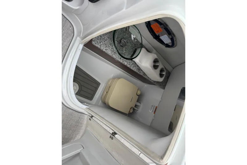 Slide: The Image of Interior of 2022 Crownline 255 SS boat featuring a compact bathroom area. - 19