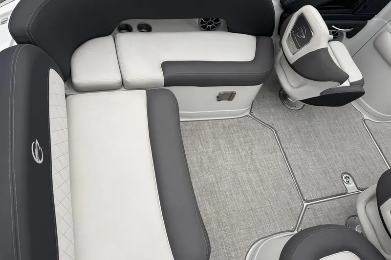 Slide: The Image of 2022 Crownline 255 SS boat interior with gray and white seating and carpeted flooring. - 9