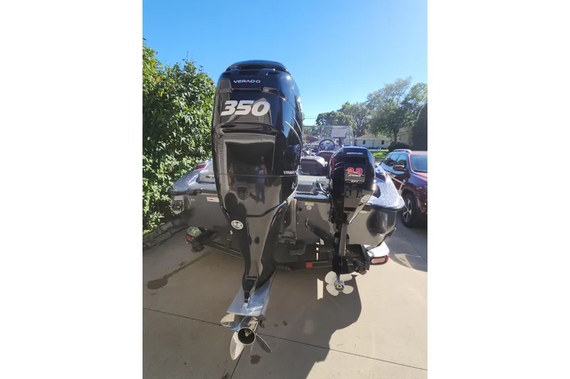 Slide: The Image of 2017 Triton 216 Fishunter boat with dual Mercury outboard motors, parked on a driveway. - 11