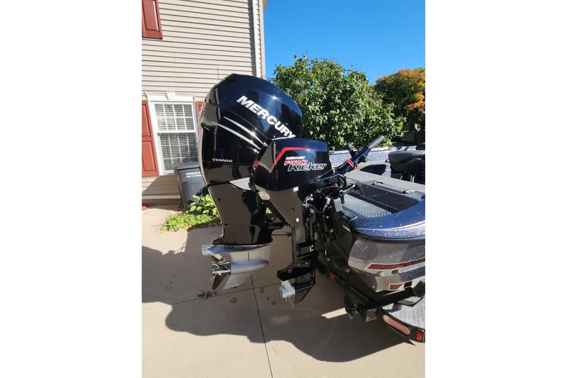 Slide: The Image of 2017 Triton 216 Fishunter with Mercury Verado outboard motor in driveway. - 12