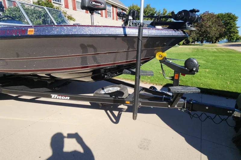 Slide: The Image of 2017 Triton 216 Fishunter boat on trailer, parked on driveway. - 13