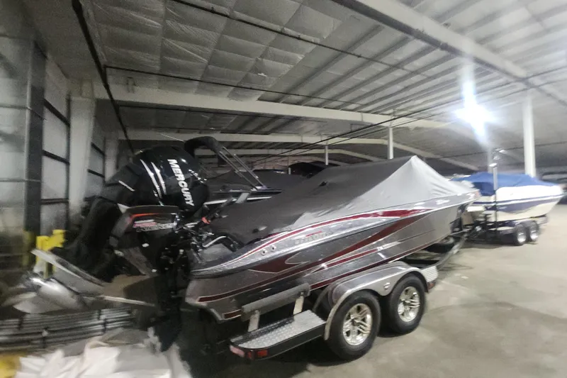 Slide: The Image of 2017 Triton 216 Fishunter boat with Mercury engine, covered and stored indoors. - 16