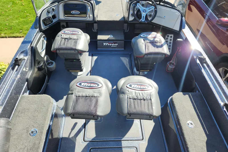 Slide: The Image of 2017 Triton 216 Fishunter boat interior with seating and steering console. - 5