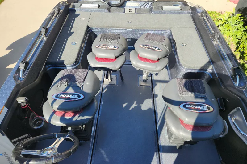 Slide: The Image of 2017 Triton 216 Fishunter boat interior with four seats and steering wheel. - 6