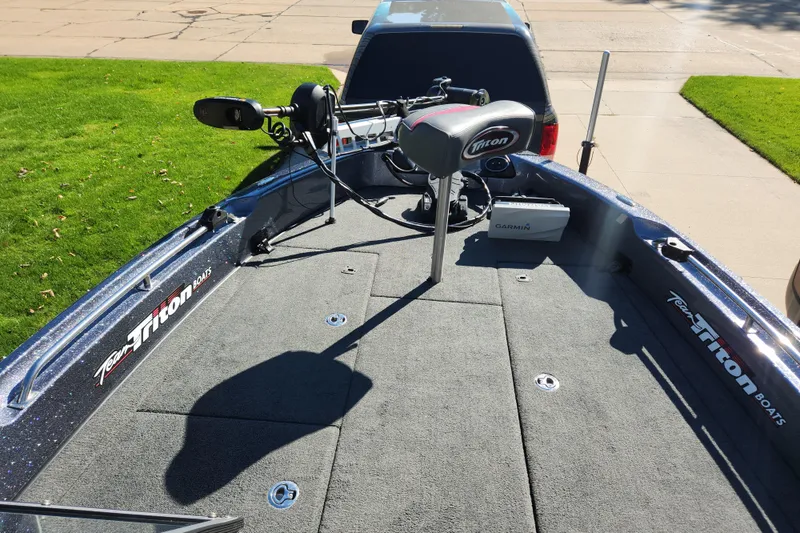 Slide: The Image of 2017 Triton 216 Fishunter boat with Garmin equipment on a sunny day. - 8